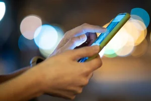 closeup of female hands holding mobile phone brows 2026